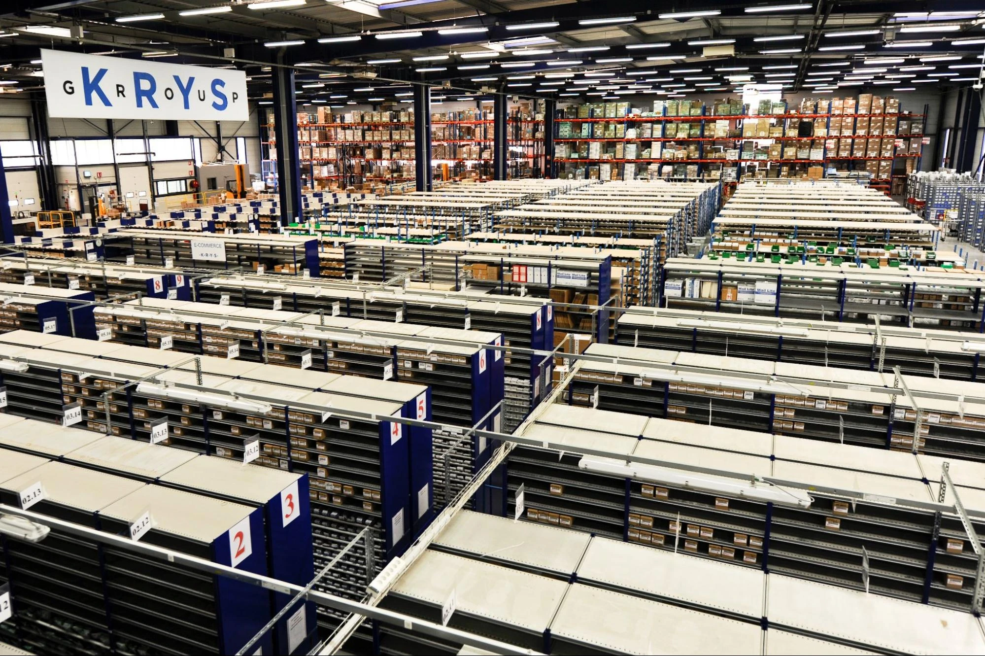 Modern e-commerce fulfillment center with automated conveyor systems and organized inventory storage